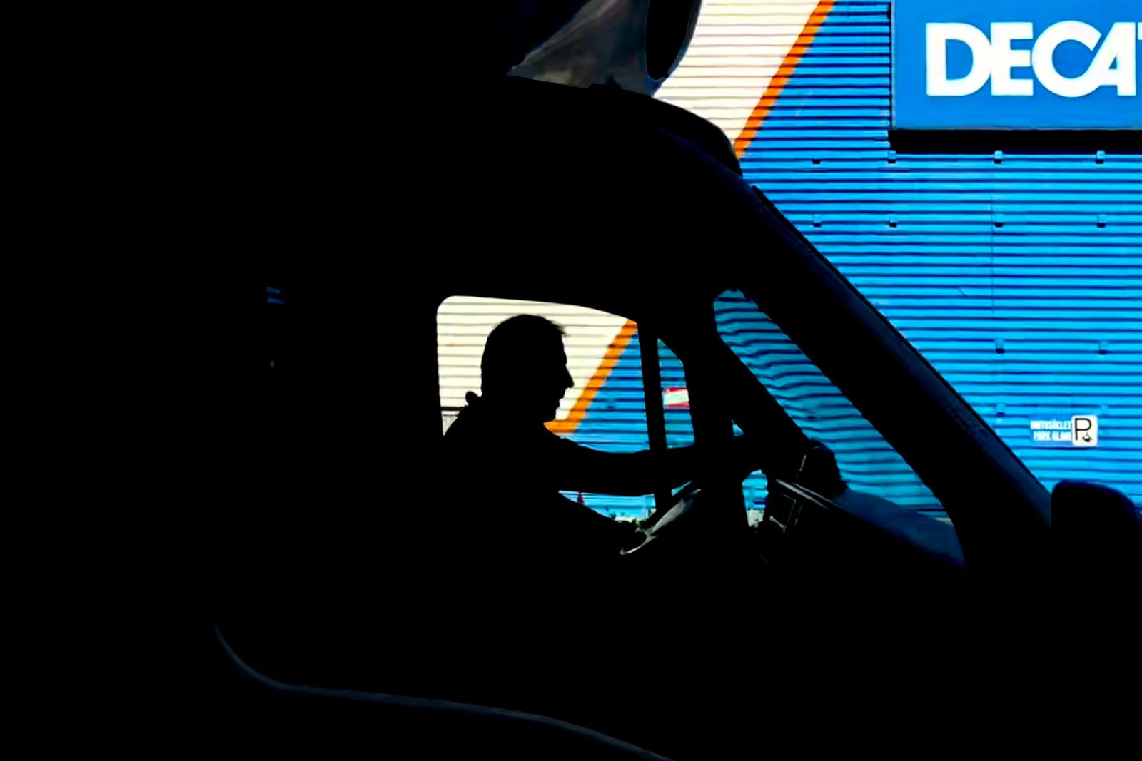A truck driver behind the wheel on the road