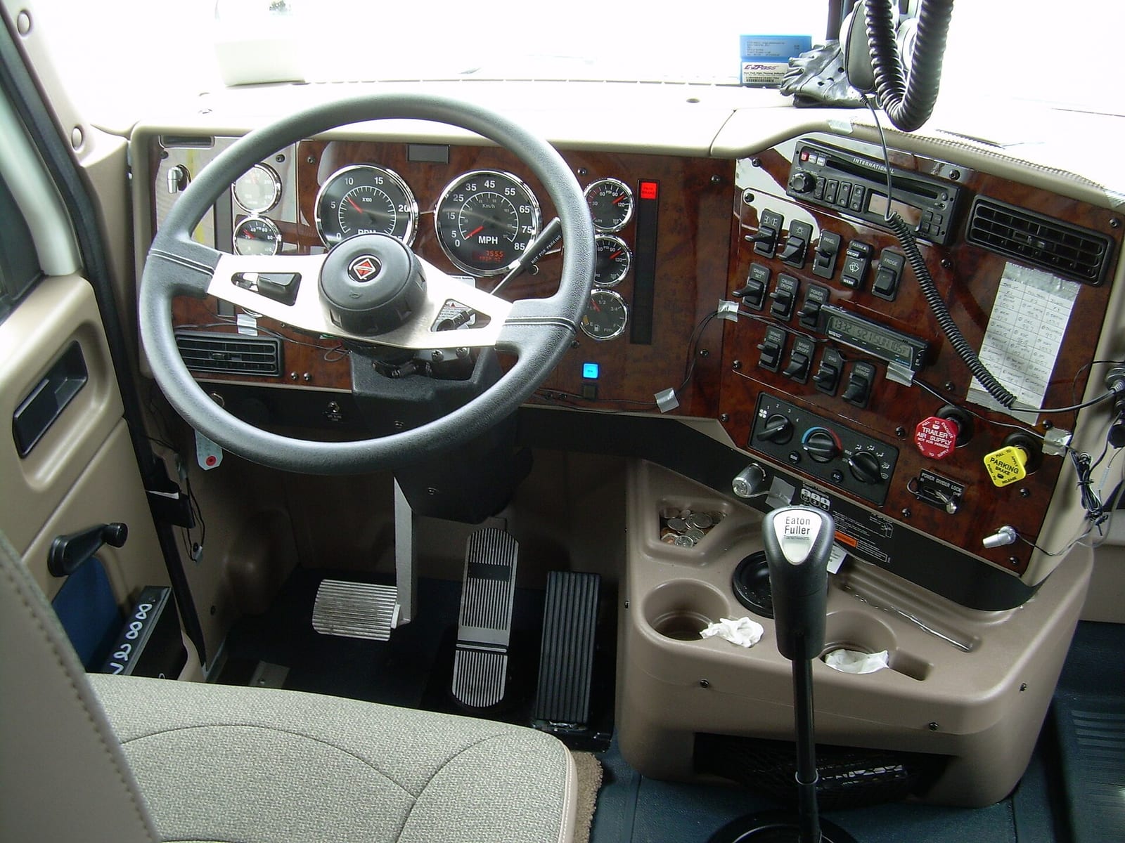 Interior of a commercial truck cab showing the dashboard controls and trailer-brake knob