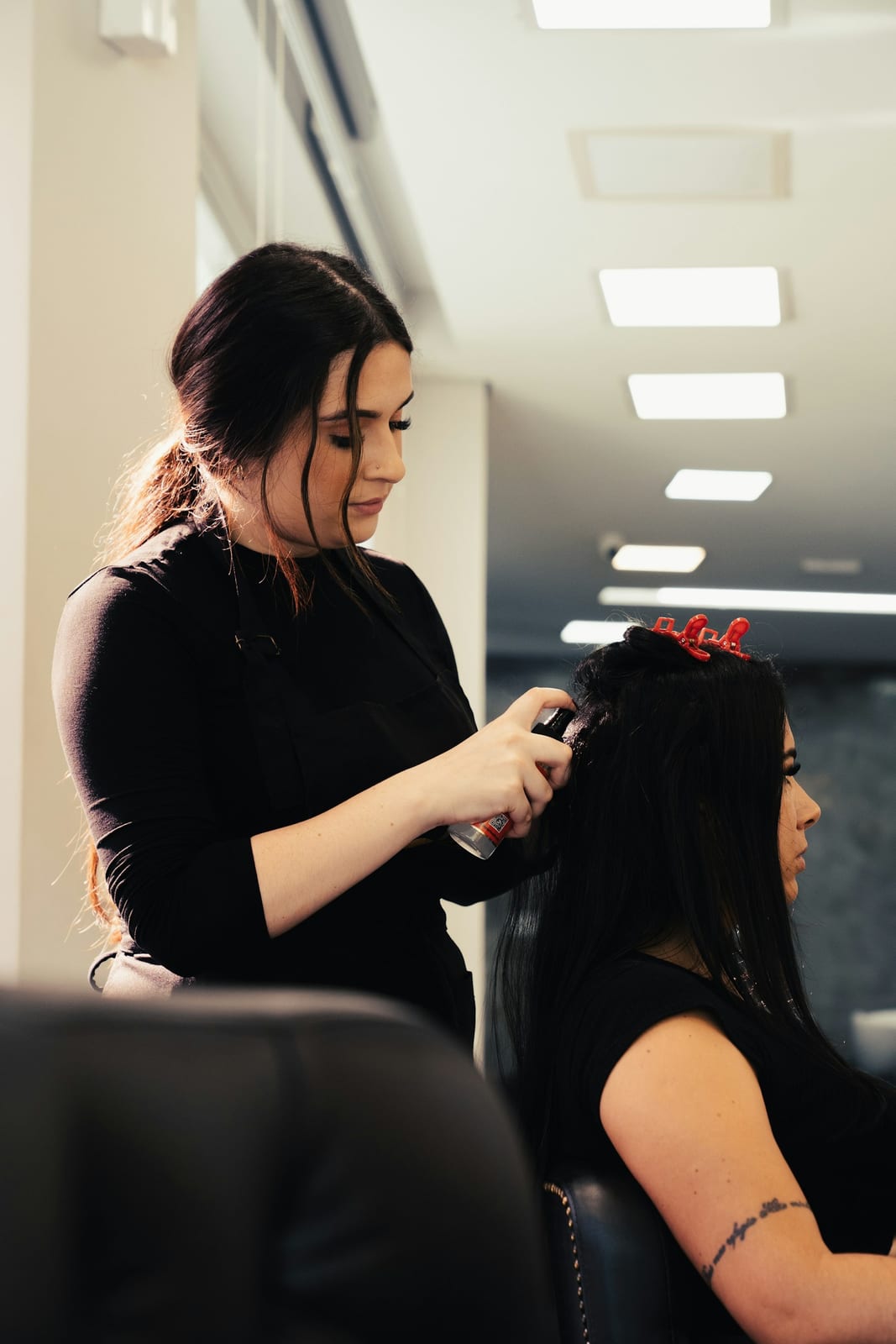 A hairstylist working on a client on the salon floor