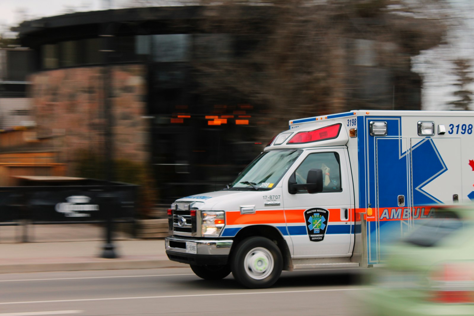 An ambulance van traveling on a road