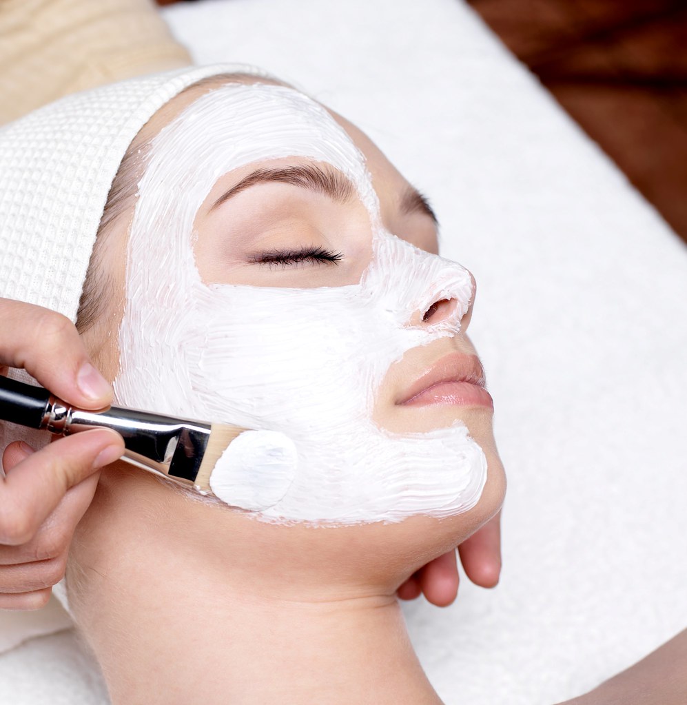 A facial treatment taking place in a spa treatment room