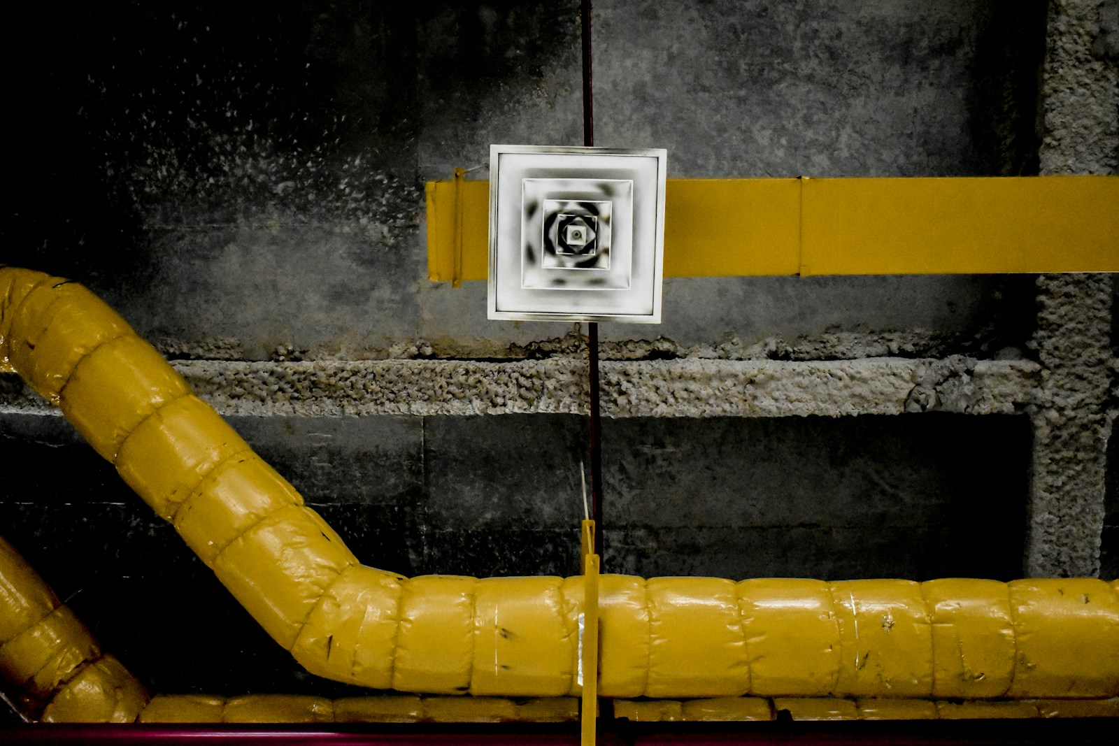 Close-up of sheet metal ductwork and an air vent