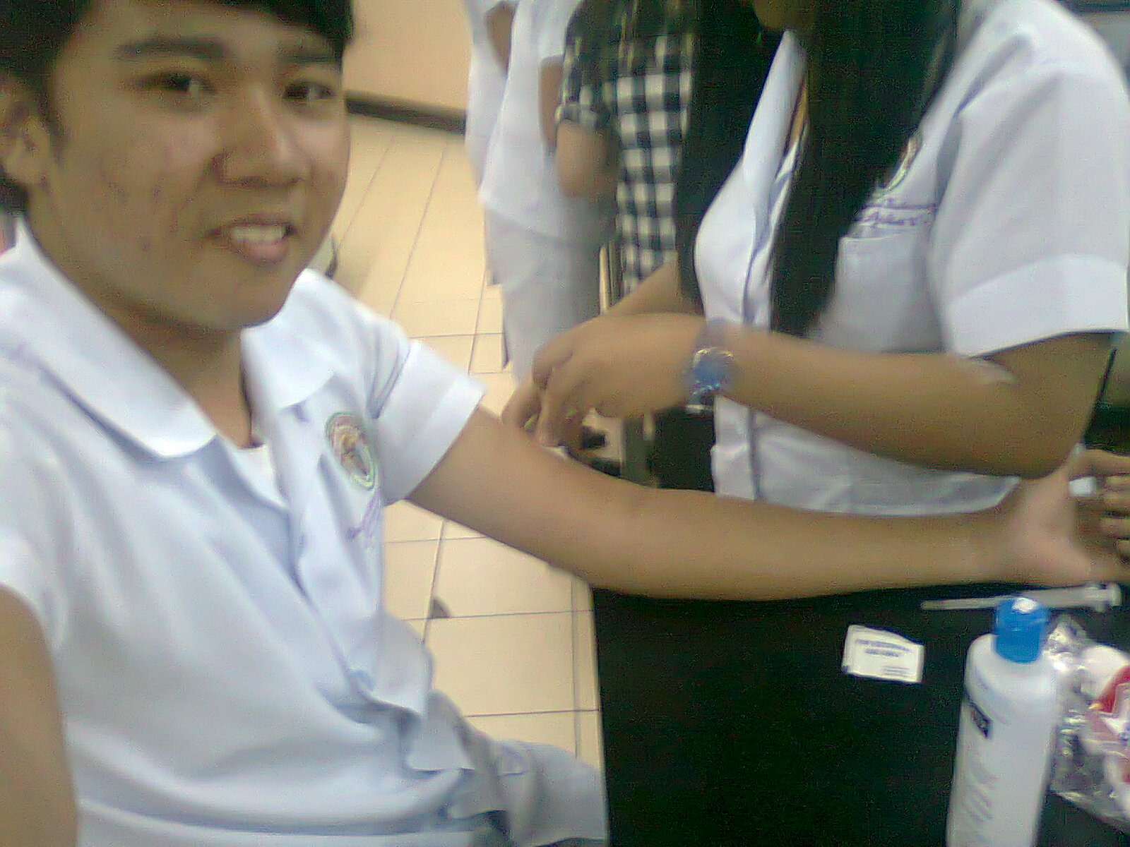 A venipuncture procedure being performed by a medical technology student