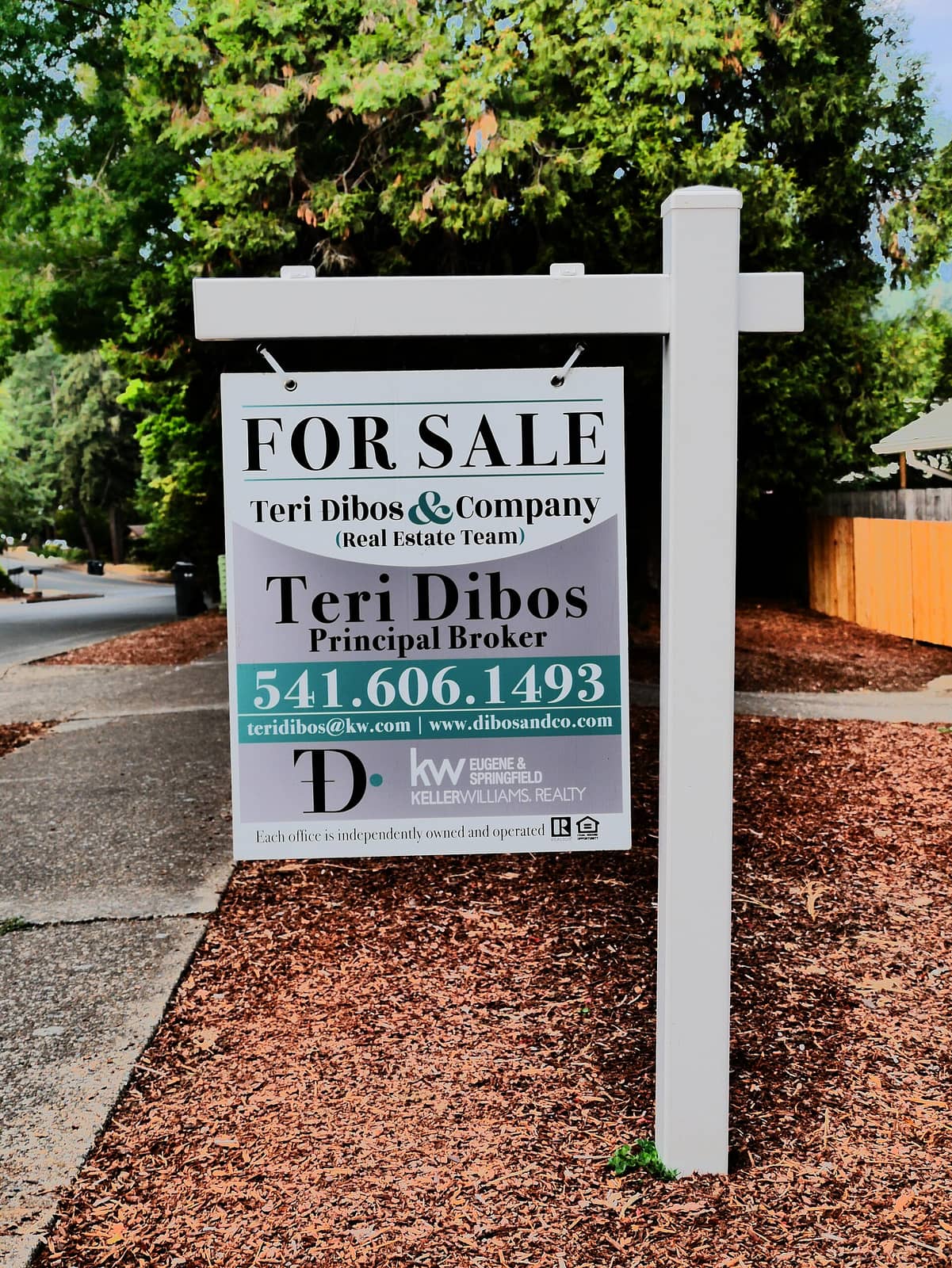 A for-sale sign in front of a residential home