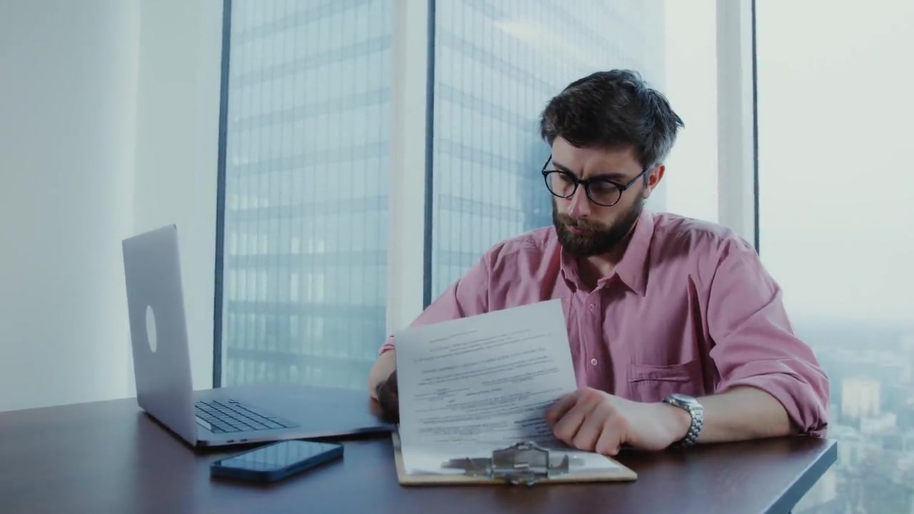 Printed paperwork being reviewed at a desk.
